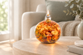 Refillable glass oil lamp with dried flowers glowing in a calm neutral interior